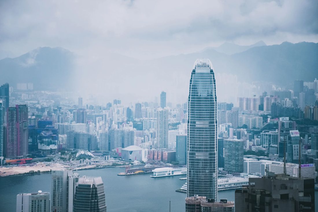 Hong Kong skyline and harbour against misty mountains